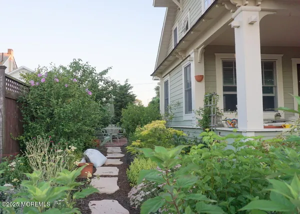 a view of backyard of house with green space
