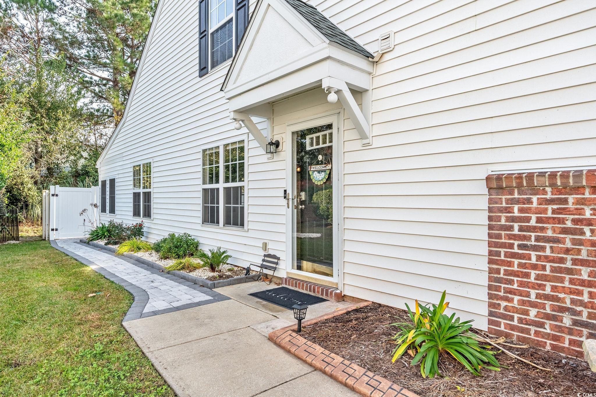 140 Wimbledon Way, Unit 140 Murrells Inlet, SC 29576 - Photo 3 of 24 Doorway to property featuring a lawn