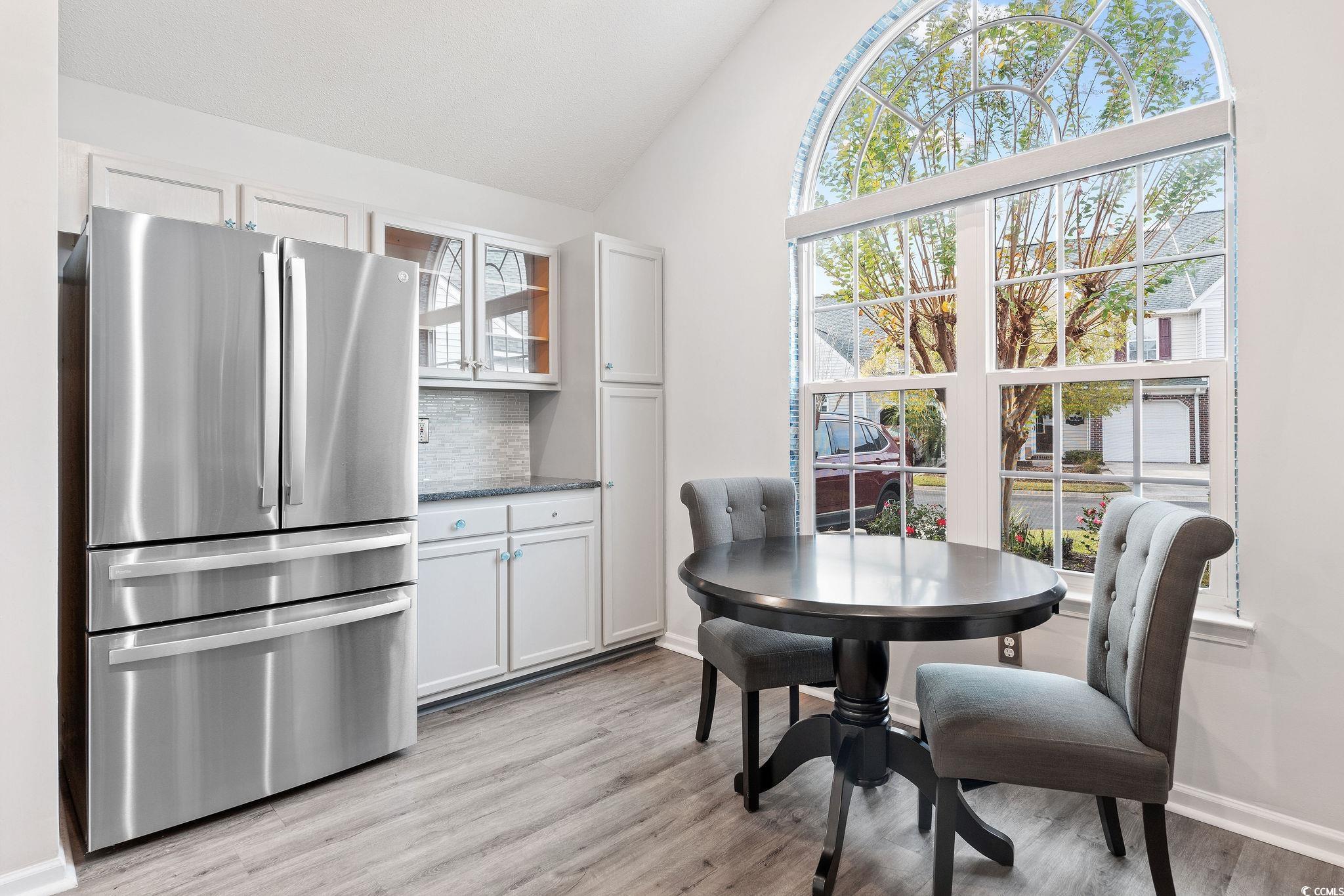 140 Wimbledon Way, Unit 140 Murrells Inlet, SC 29576 - Photo 8 of 24 Dining area with high vaulted ceiling and light wo