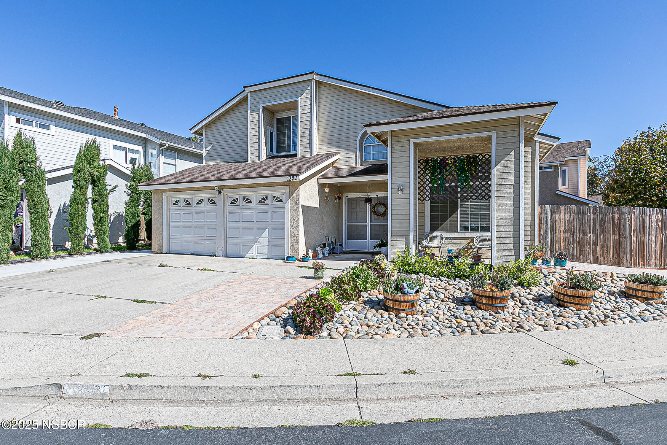 1320 Marigold Way Lompoc, CA 93436 - Photo 2 of 42 a front view of a house with a garden