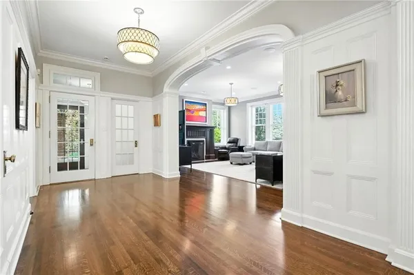 a view of a livingroom with furniture wooden floor and windows