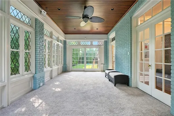 a spacious bedroom with a large bed and a large window