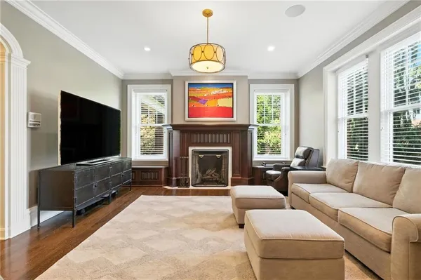 a living room with furniture a flat screen tv and a fireplace