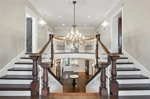 a view of entryway and hall with wooden floor