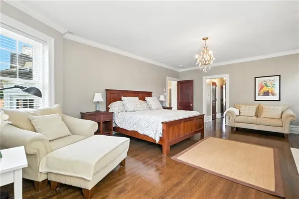 a bedroom with two beds and a chandelier