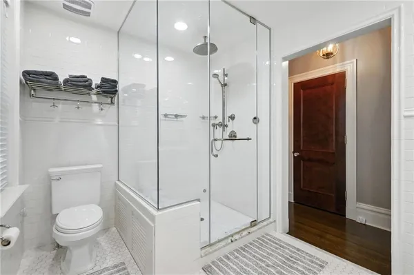 a bathroom with a toilet a sink and shower
