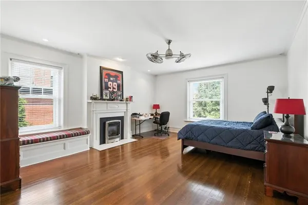a bedroom with a bed and a fireplace