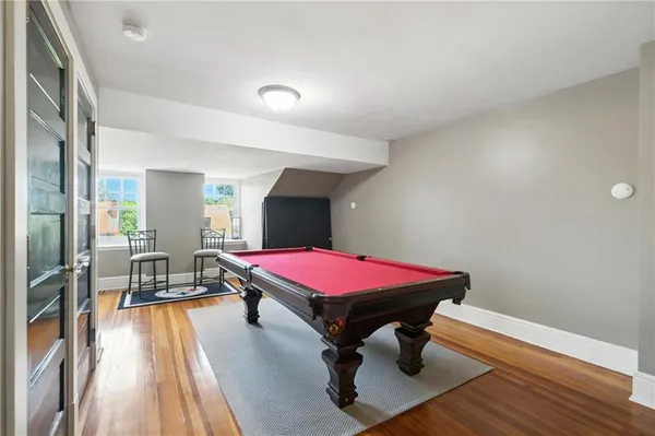 a room with pool table table and wooden floor