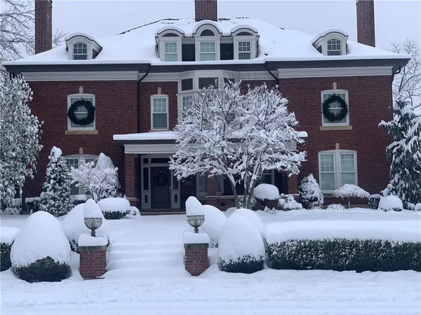 a front view of a house with sitting area