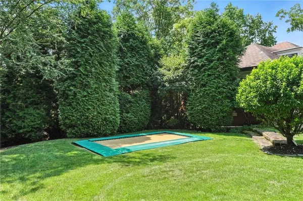a view of a swimming pool and a yard