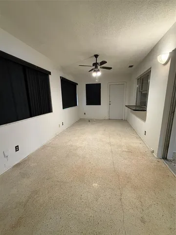 a view of an empty room with a fireplace