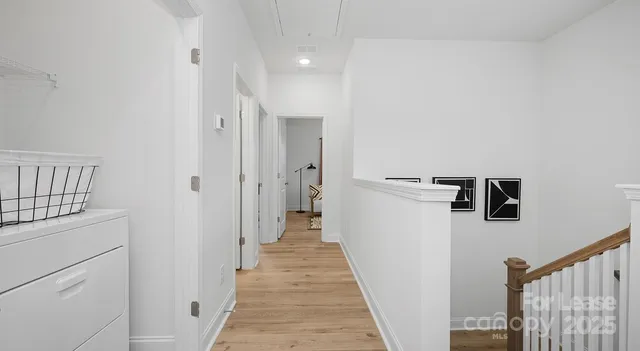 a view of a hallway with closet and appliance