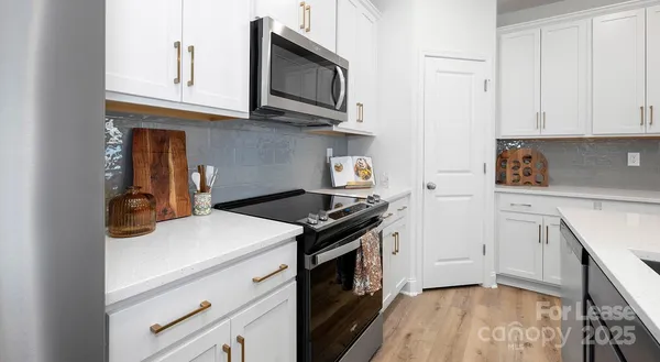 a kitchen with stainless steel appliances granite countertop a stove and a microwave