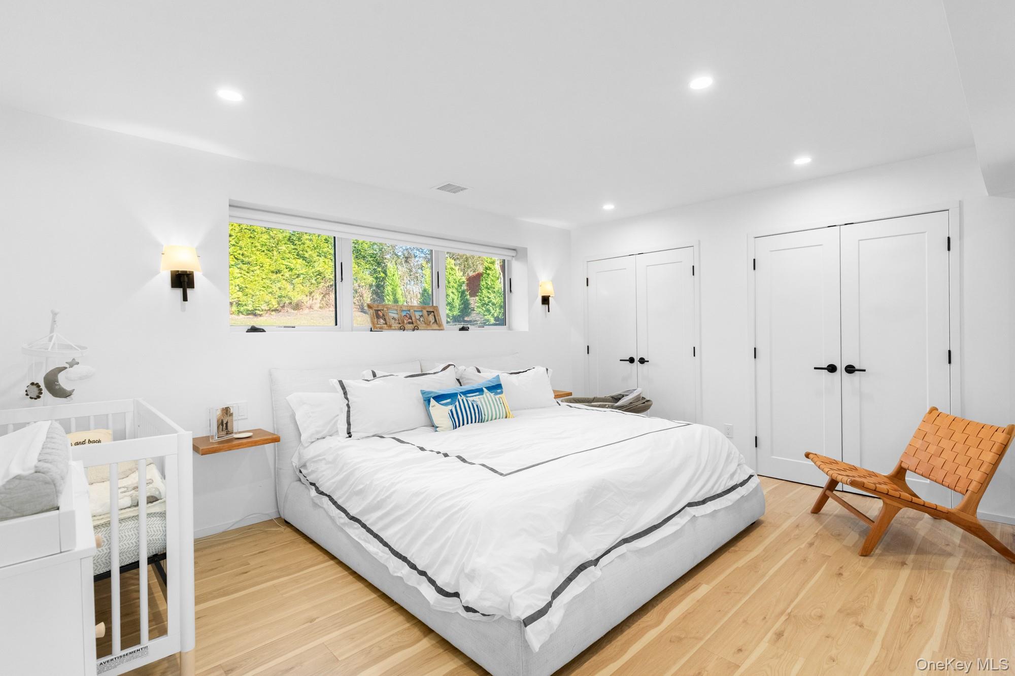 238 Sebonac Road Southampton, NY 11968 - Photo 17 of 23 a bedroom with a bed and a chair