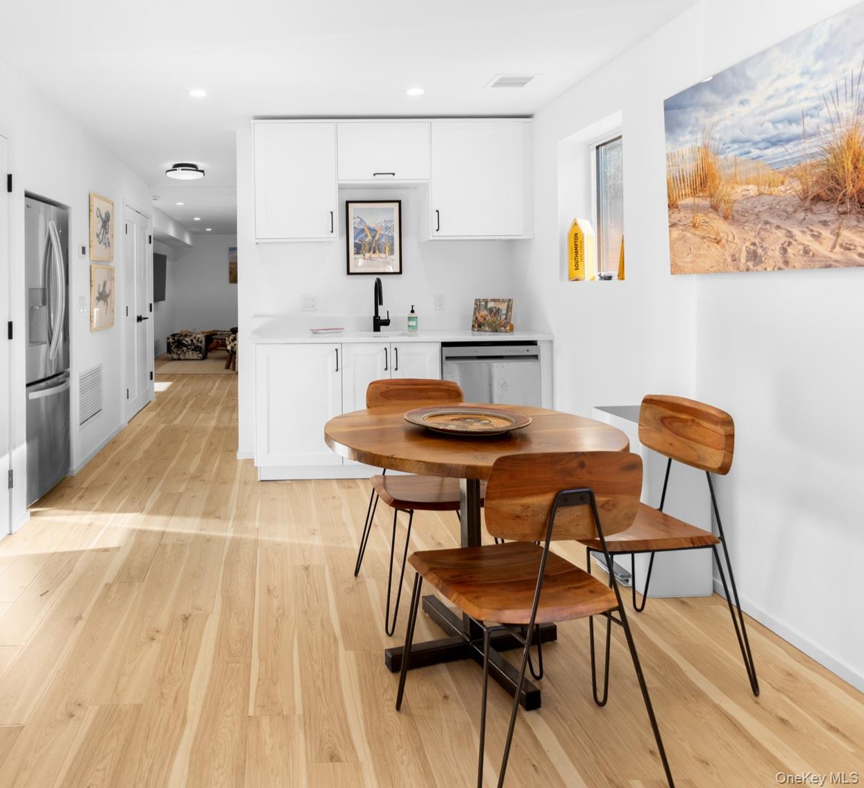 238 Sebonac Road Southampton, NY 11968 - Photo 19 of 23 a view of a dining room with furniture and a wooden floor