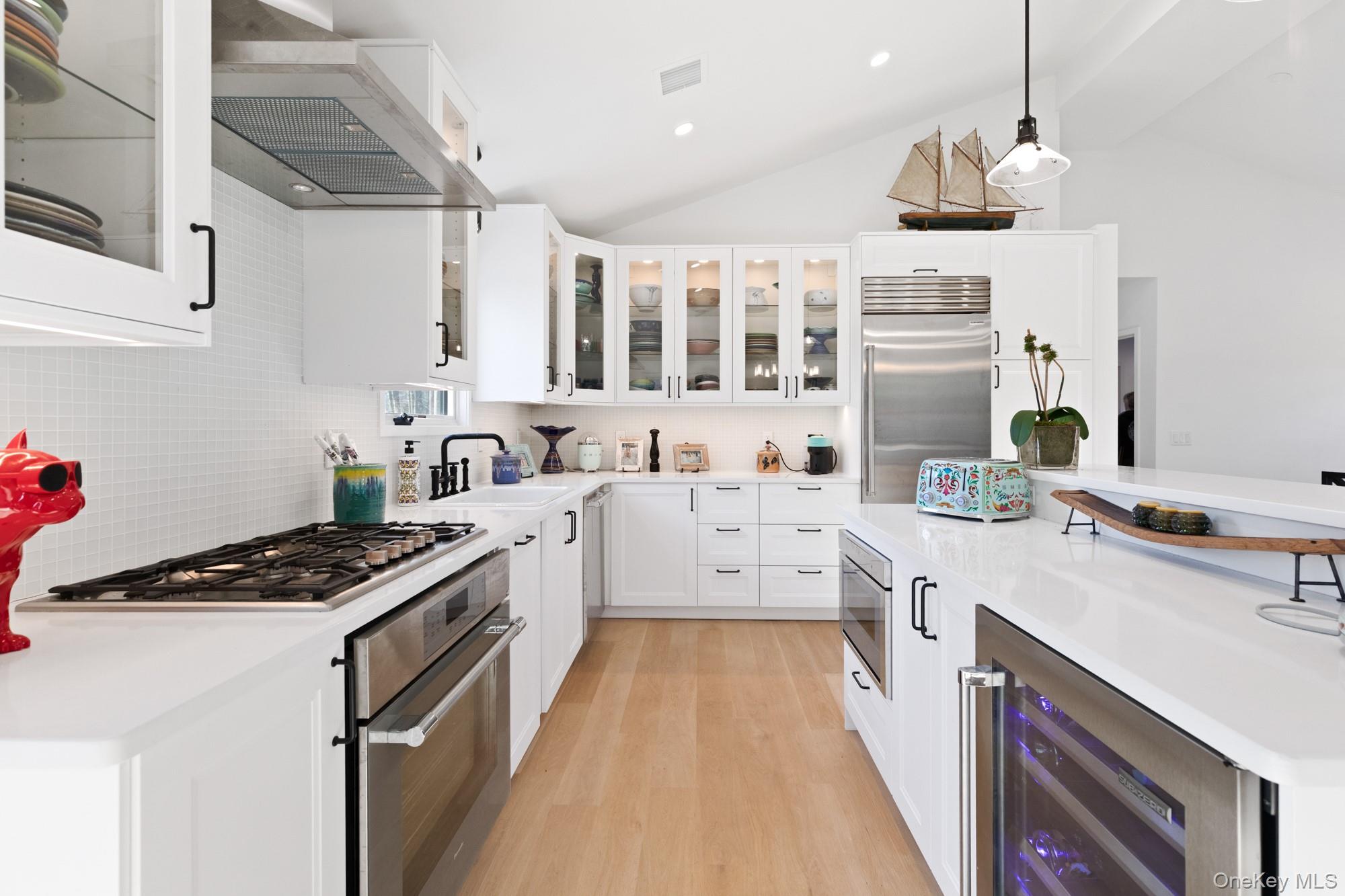 238 Sebonac Road Southampton, NY 11968 - Photo 6 of 23 a kitchen that has a lot of cabinets in it and wooden floors