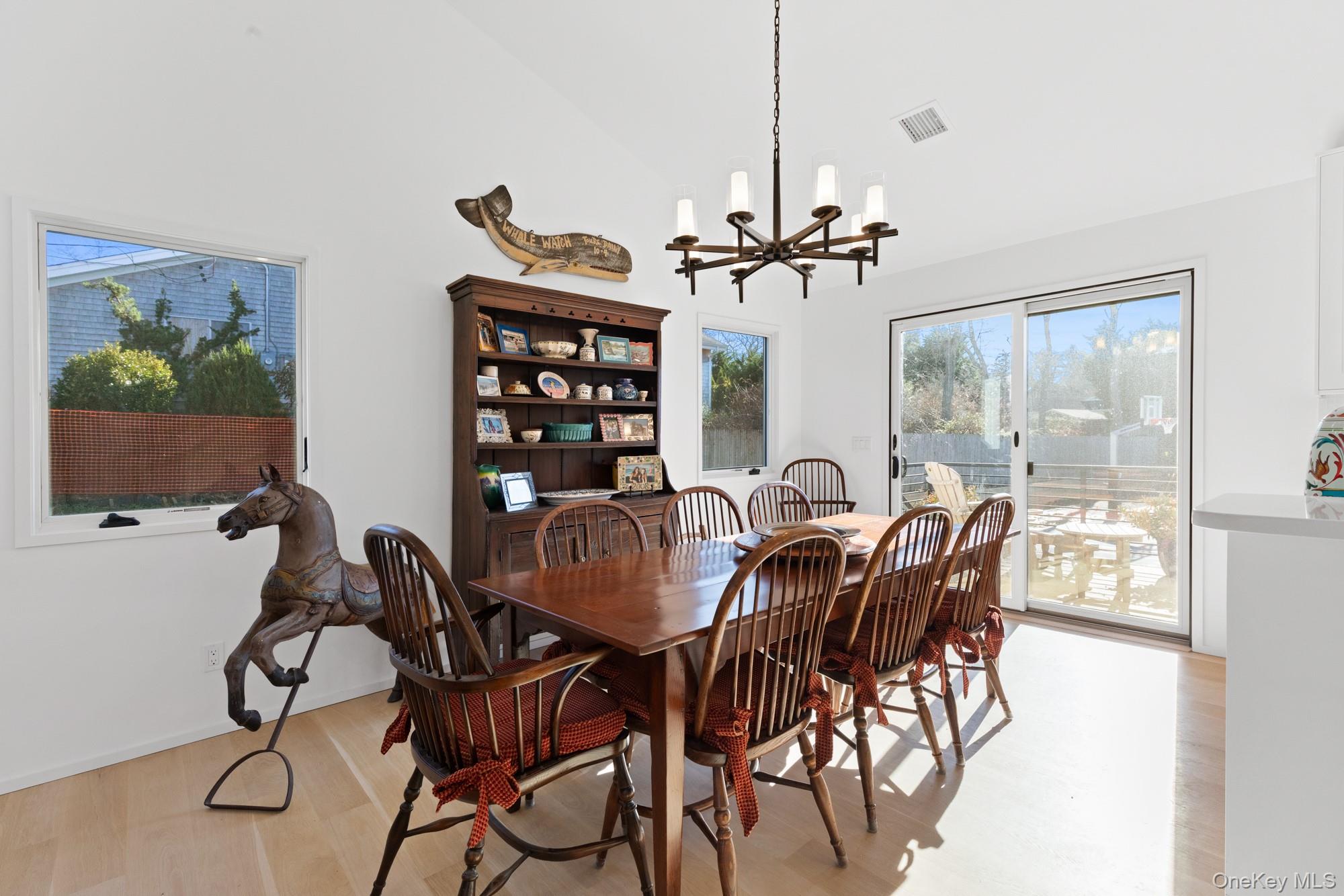 238 Sebonac Road Southampton, NY 11968 - Photo 9 of 23 a view of a dining room with furniture and chandelier