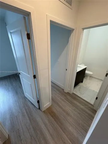 an entryway with a floor to ceiling window and wooden floor