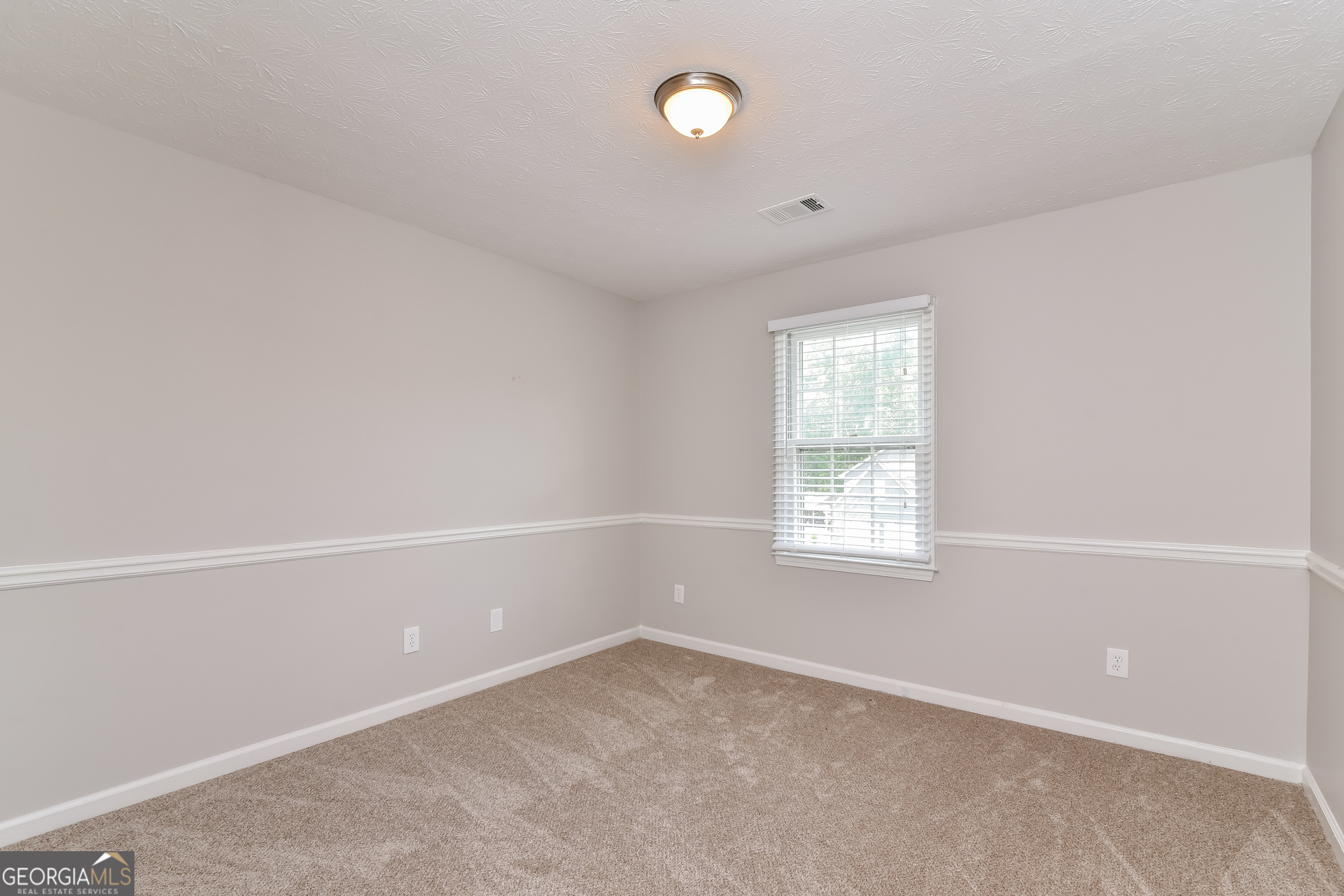 2935 Emerson Lake Drive Snellville, GA 30078 - Photo 11 of 15 an empty room with a window