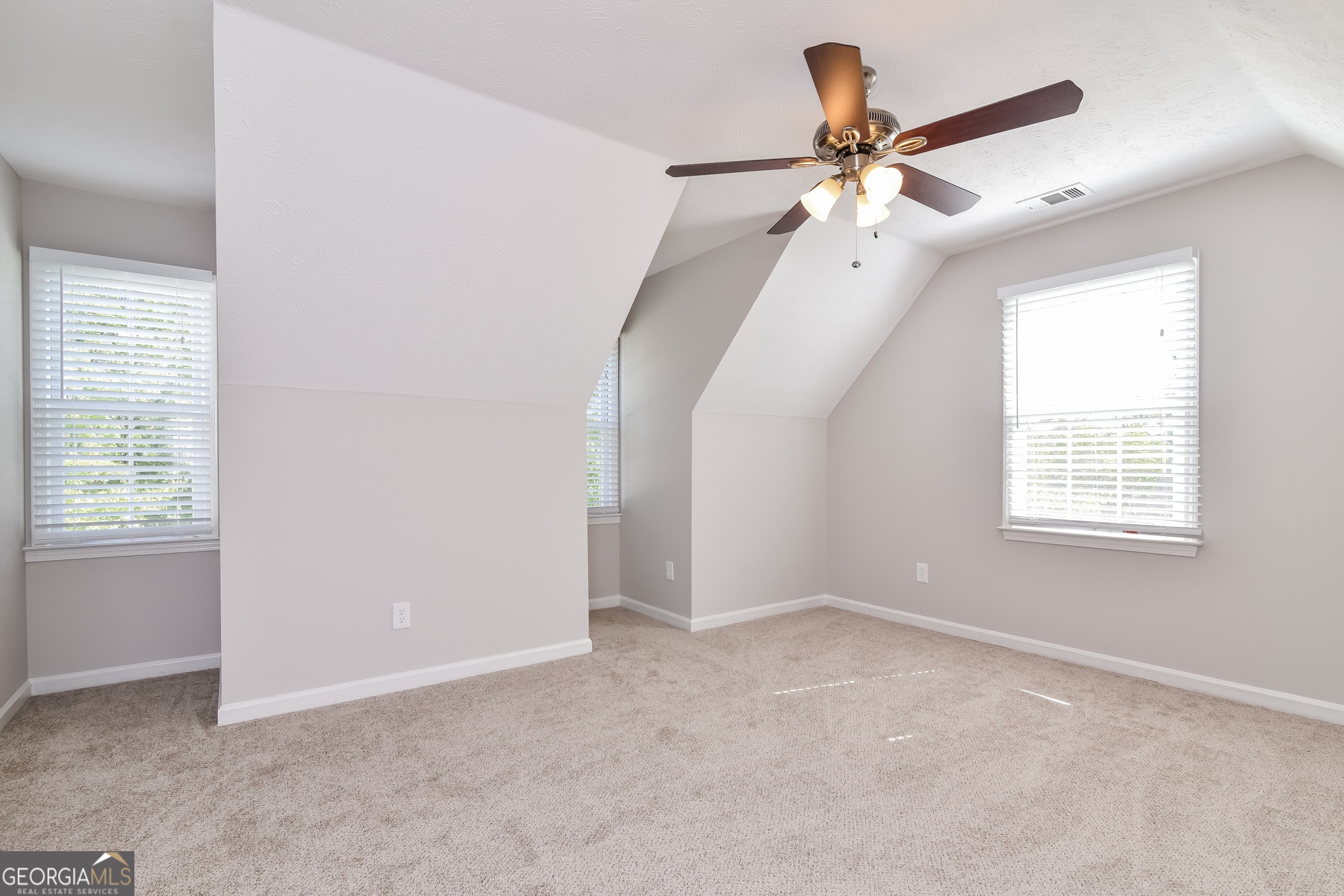 2935 Emerson Lake Drive Snellville, GA 30078 - Photo 13 of 15 an empty room with fan and windows