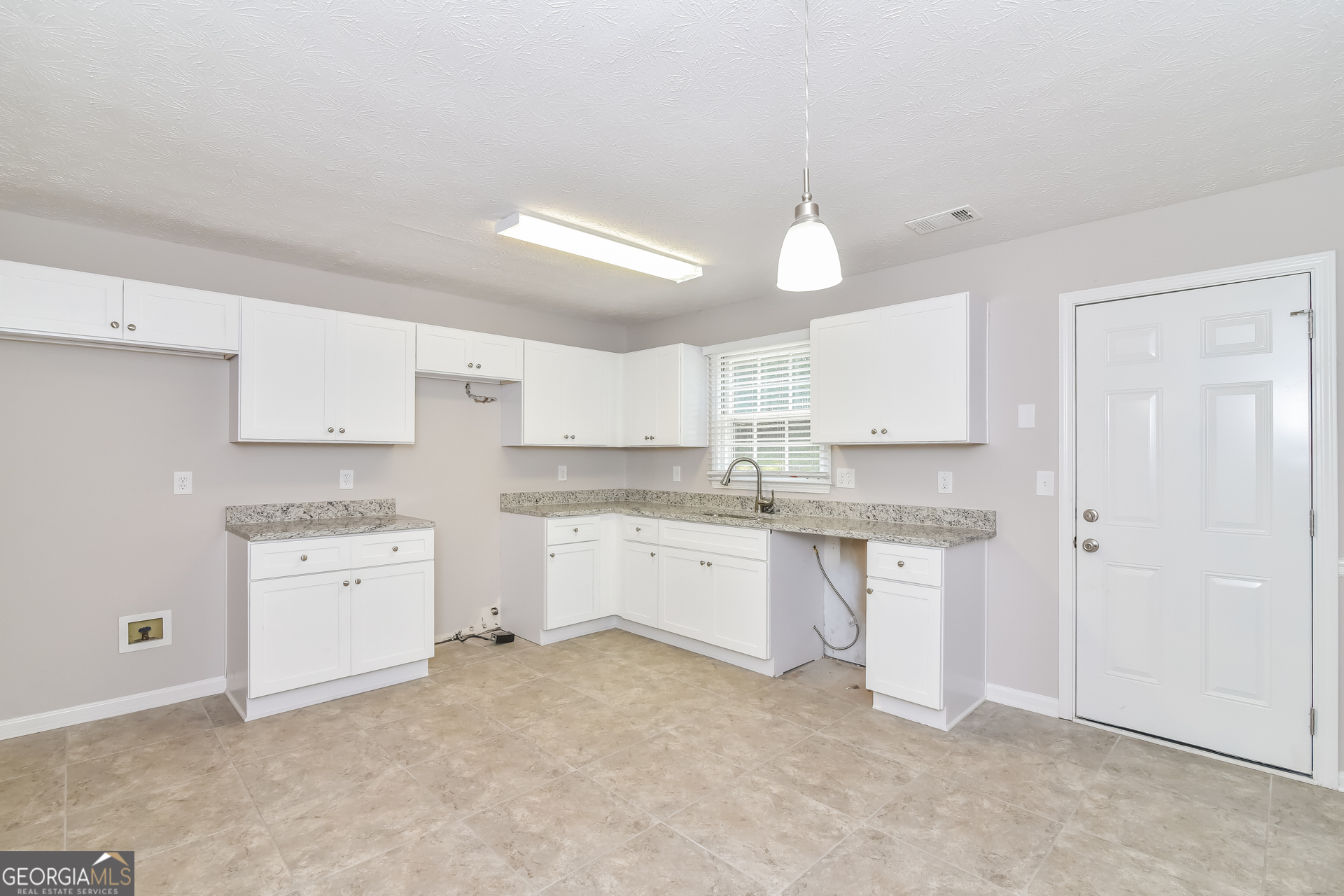 2935 Emerson Lake Drive Snellville, GA 30078 - Photo 6 of 15 a kitchen with white cabinets and sink