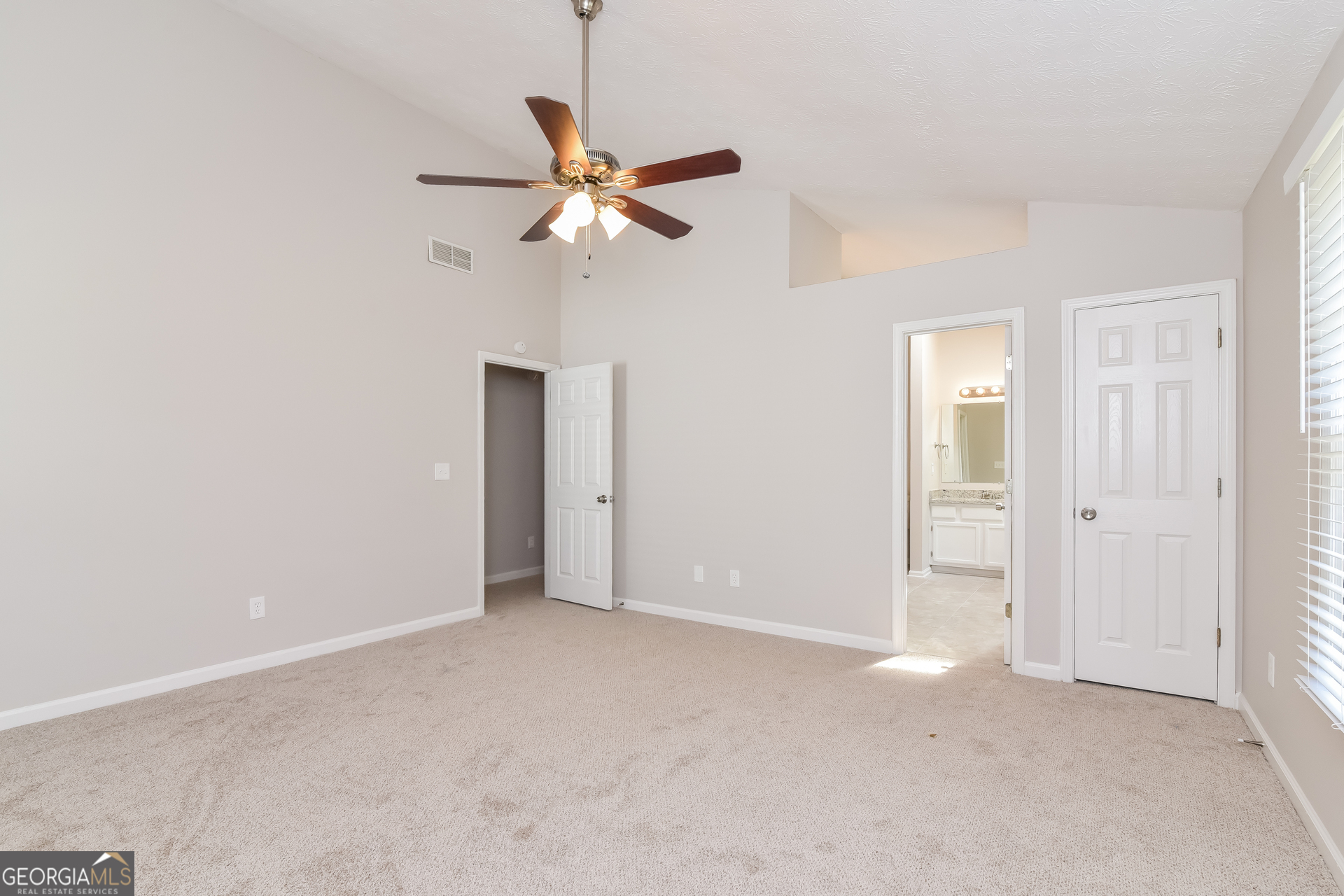 2935 Emerson Lake Drive Snellville, GA 30078 - Photo 9 of 15 an empty room with a fan and a window
