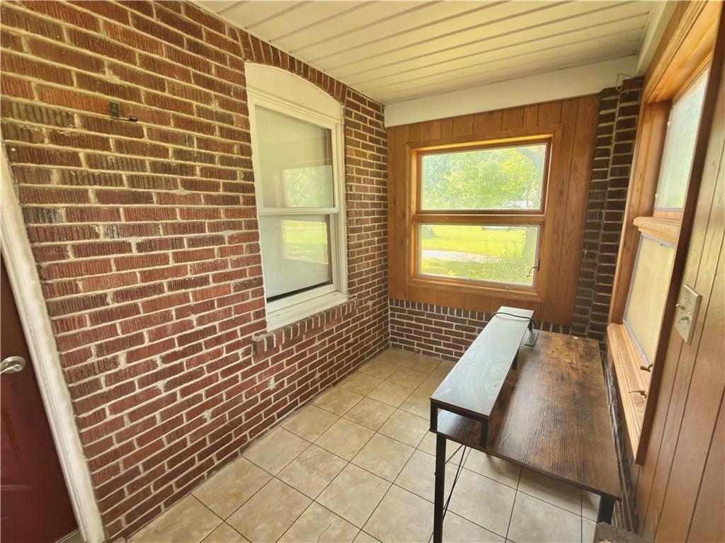 4550 Vera Cruz Road Center Valley, PA 18034 - Photo 17 of 43 Tiled flooring and exposed brick walls define this versatile enclosed porch space.