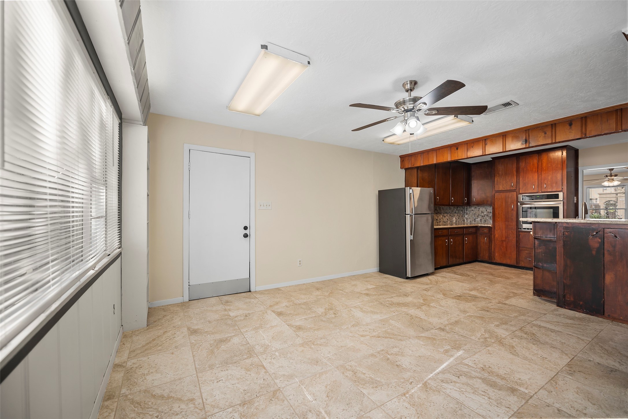 4111 Law Street West University Place, TX 77005 - Photo 17 of 29 a view of a kitchen with furniture and a ceiling fan