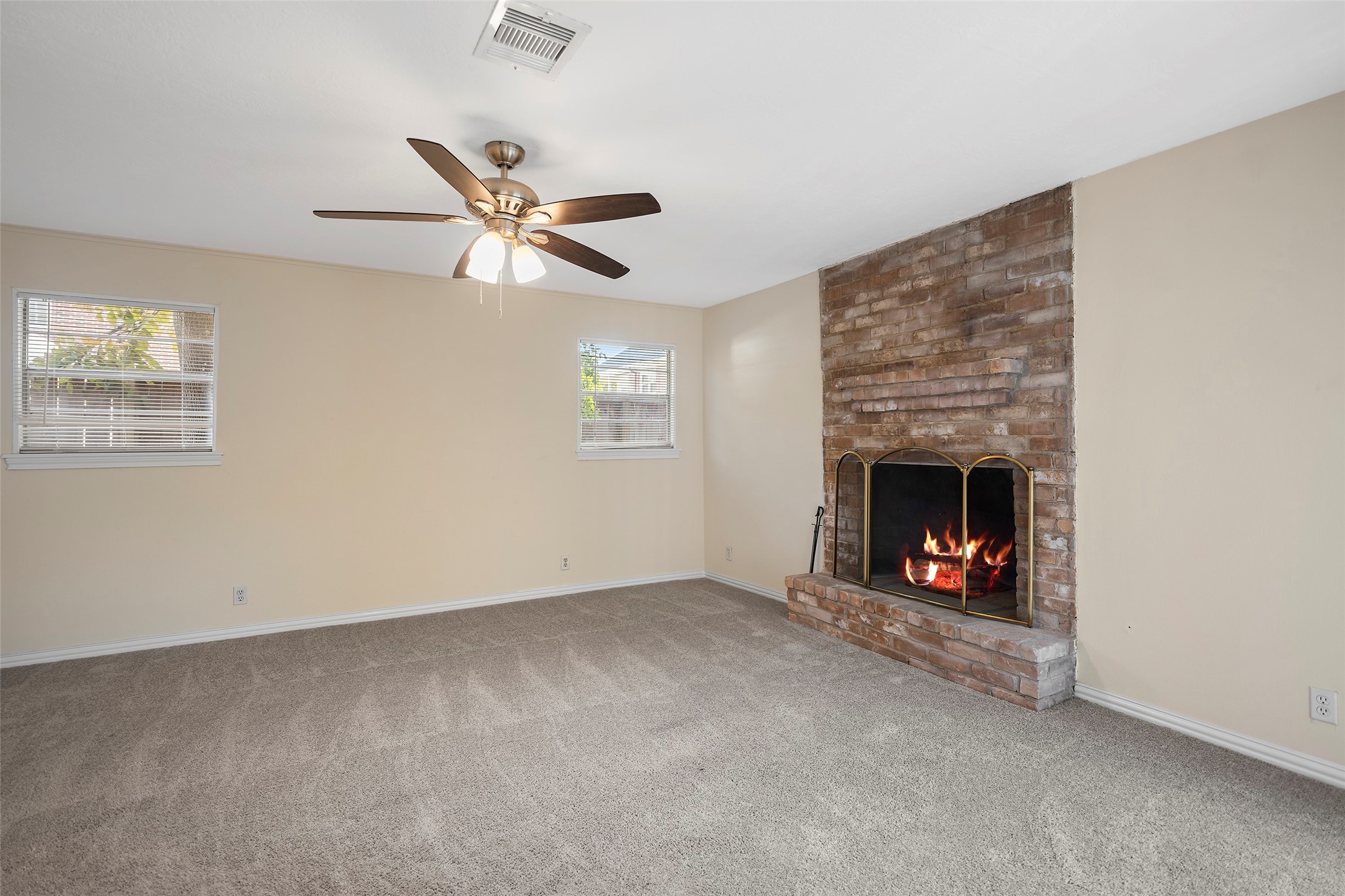 4111 Law Street West University Place, TX 77005 - Photo 25 of 29 an empty room with a fireplace and fan