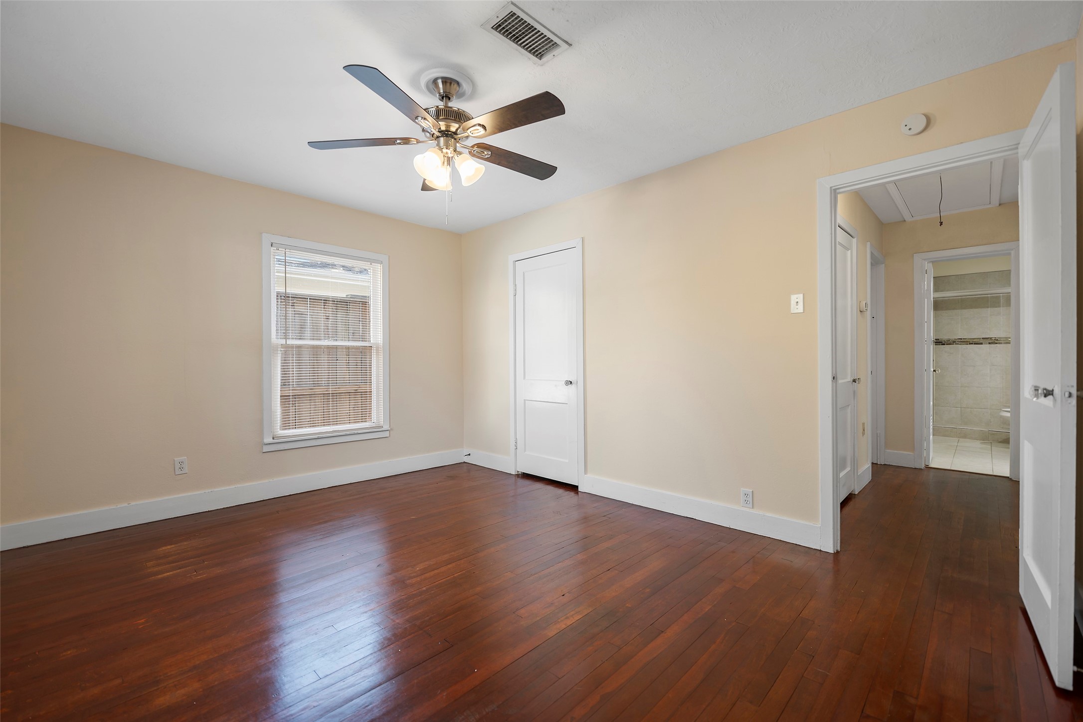 4111 Law Street West University Place, TX 77005 - Photo 8 of 29 a view of an empty room with wooden floor and a window