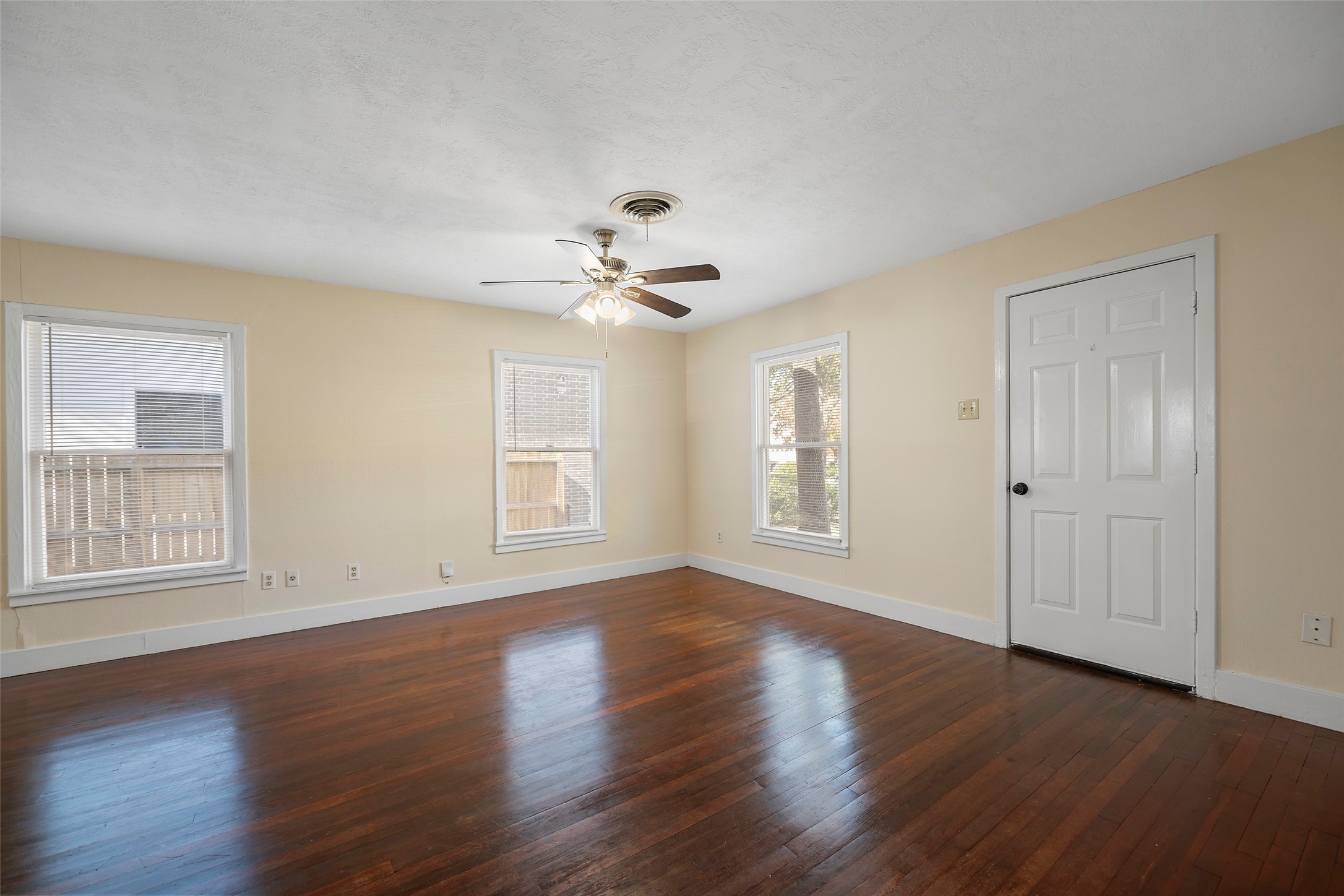 4111 Law Street West University Place, TX 77005 - Photo 9 of 29 a view of an empty room with a window and wooden floor