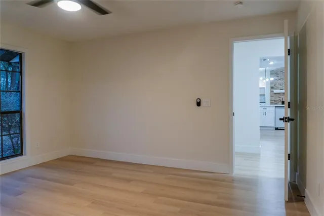 wooden floor in an empty room with a window