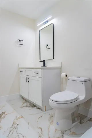an empty room with wooden floor and chandelier fan