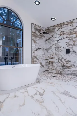 a view of an empty room with wooden floor and closet