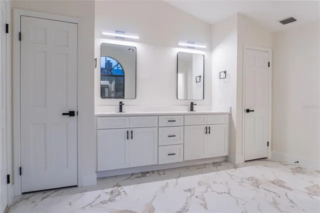 a living room with a fireplace and a ceiling fan