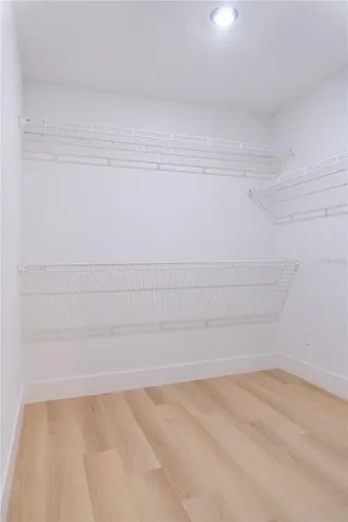 a living room with a fireplace and a ceiling fan