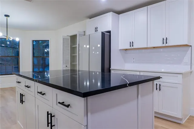 a kitchen with stainless steel appliances a refrigerator and cabinets