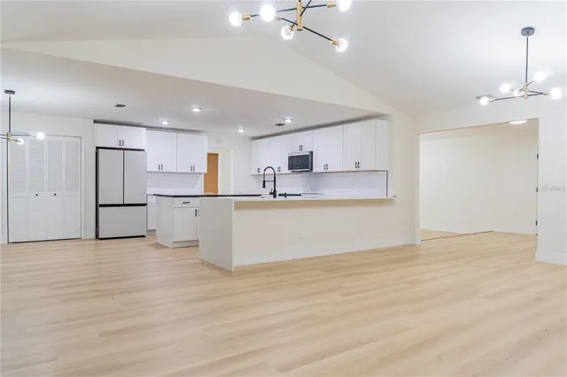 a view of kitchen with wooden cabinet