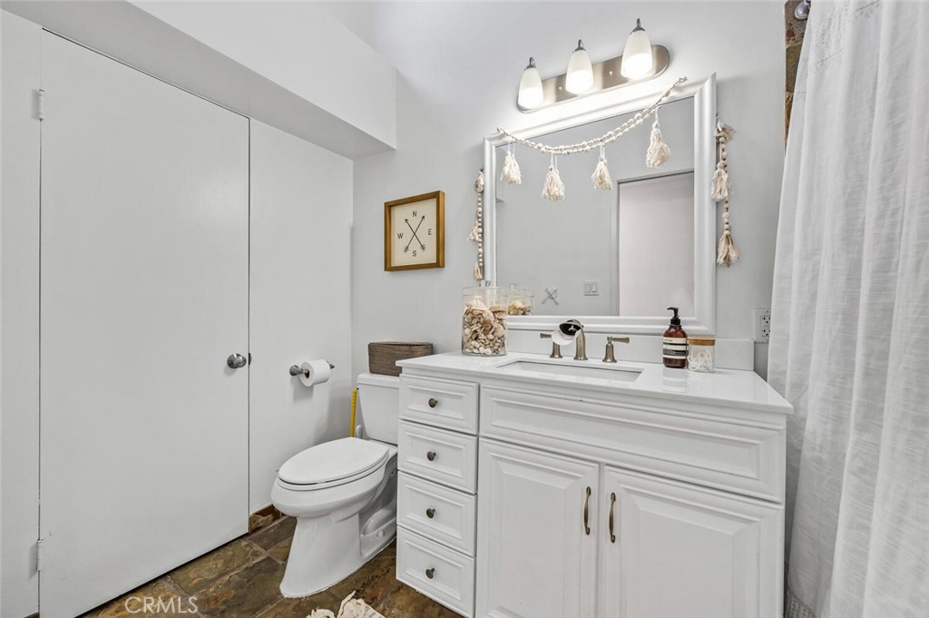 283 Lilac Lane Costa Mesa, CA 92627 - Photo 18 of 22 a bathroom with a sink a toilet and a mirror