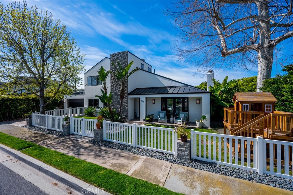 283 Lilac Lane Costa Mesa, CA 92627 - Photo 2 of 22 a house view with a garden and deck