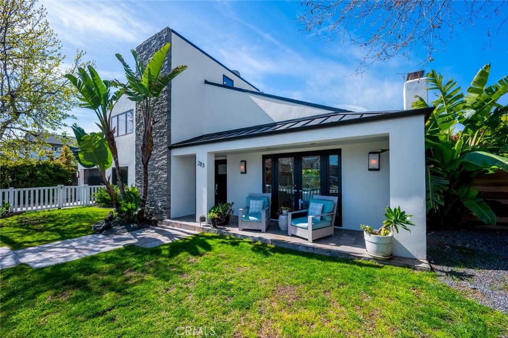 283 Lilac Lane Costa Mesa, CA 92627 - Photo 3 of 22 a view of a house with a yard and plants