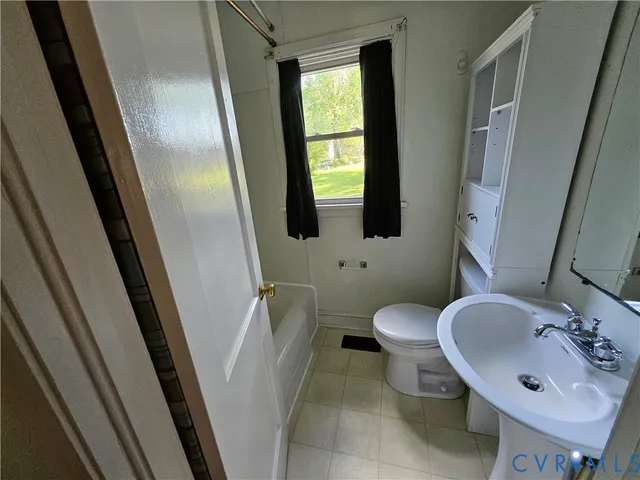 a bathroom with a sink toilet and mirror