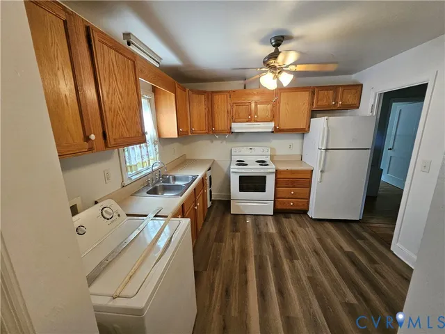 a kitchen with a refrigerator a stove top oven a sink and dishwasher