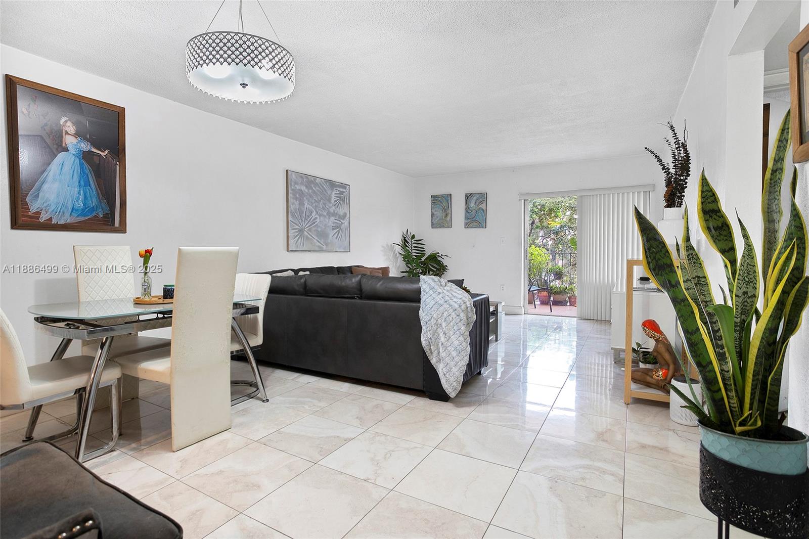 1850 West 56th Street, Unit 2207 Hialeah, FL 33012 - Photo 12 of 33 a living room with furniture a fireplace and a potted plant