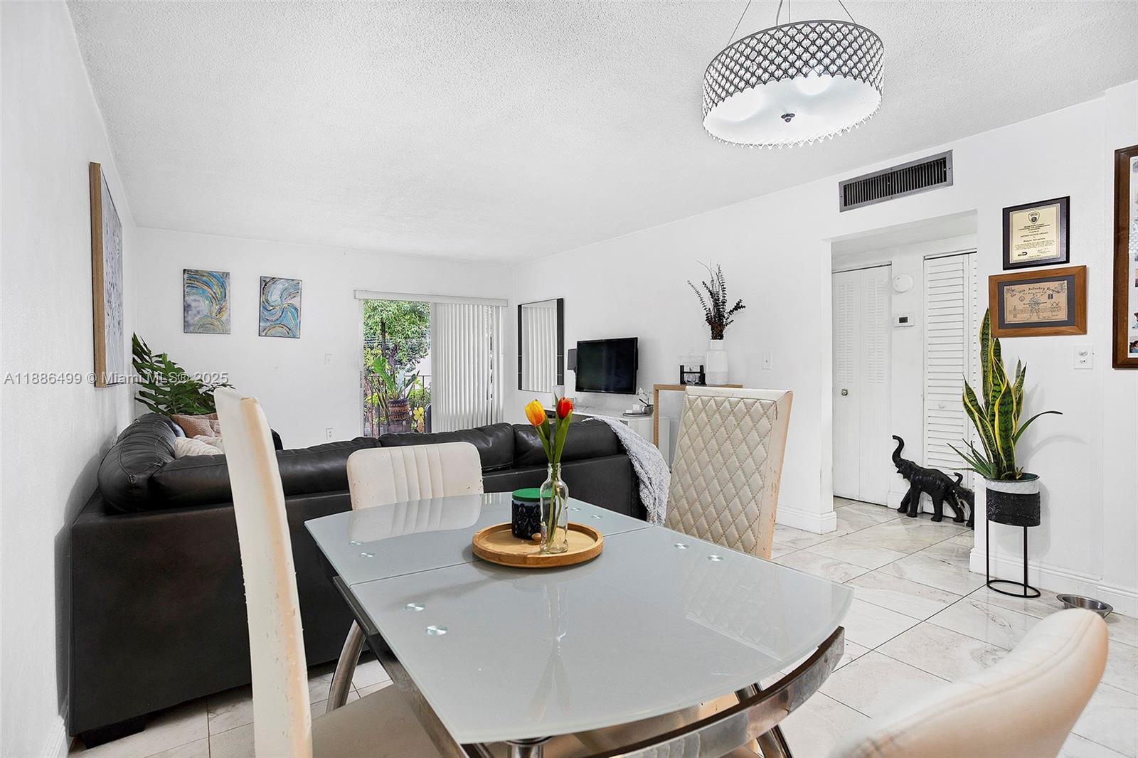 1850 West 56th Street, Unit 2207 Hialeah, FL 33012 - Photo 16 of 33 a view of a dining room with furniture and wooden floor