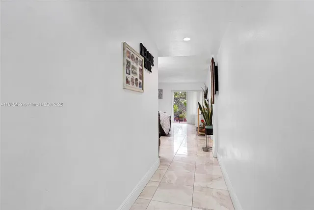 a hallway with a table and chairs