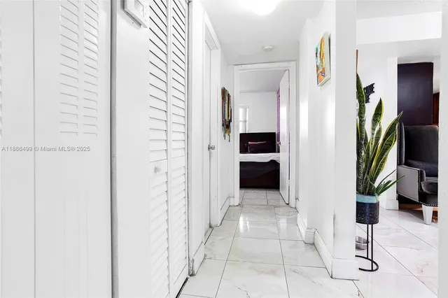 a spacious bedroom with a bed and a dresser