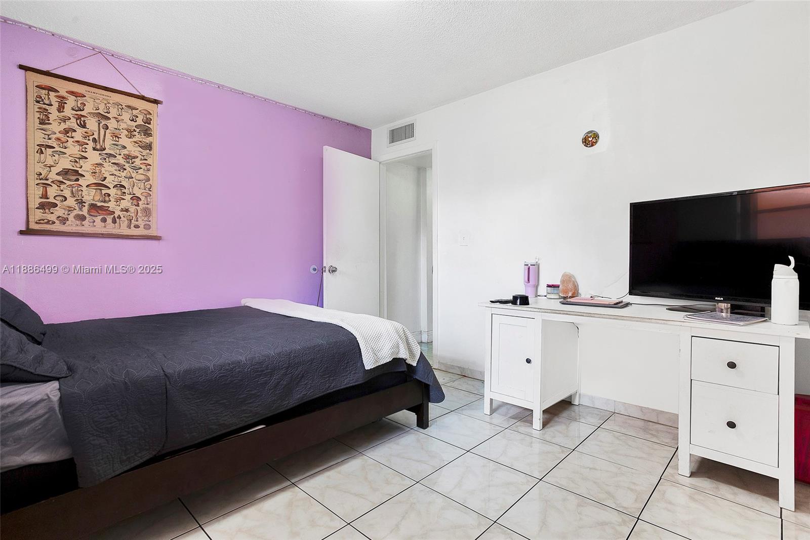 1850 West 56th Street, Unit 2207 Hialeah, FL 33012 - Photo 20 of 33 a bedroom with a bed and a flat screen tv