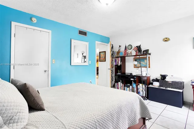 a bed room with a bed and a television