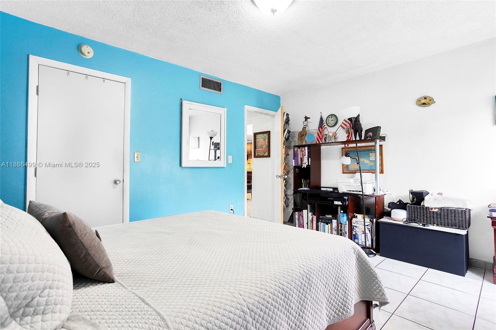 1850 West 56th Street, Unit 2207 Hialeah, FL 33012 - Photo 25 of 33 a bedroom with a bed and a large mirror